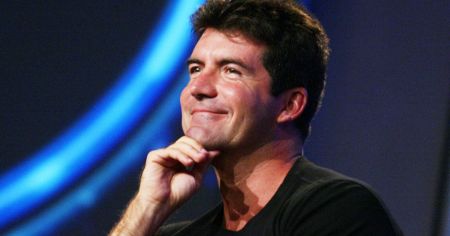 British Got Talent judge Simon Cowell in a black t-shirt caught at the camera.